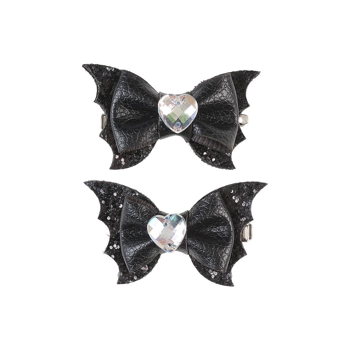 Two black butterfly-shaped hair bows with heart-shaped gemstones on a white background by Souza!